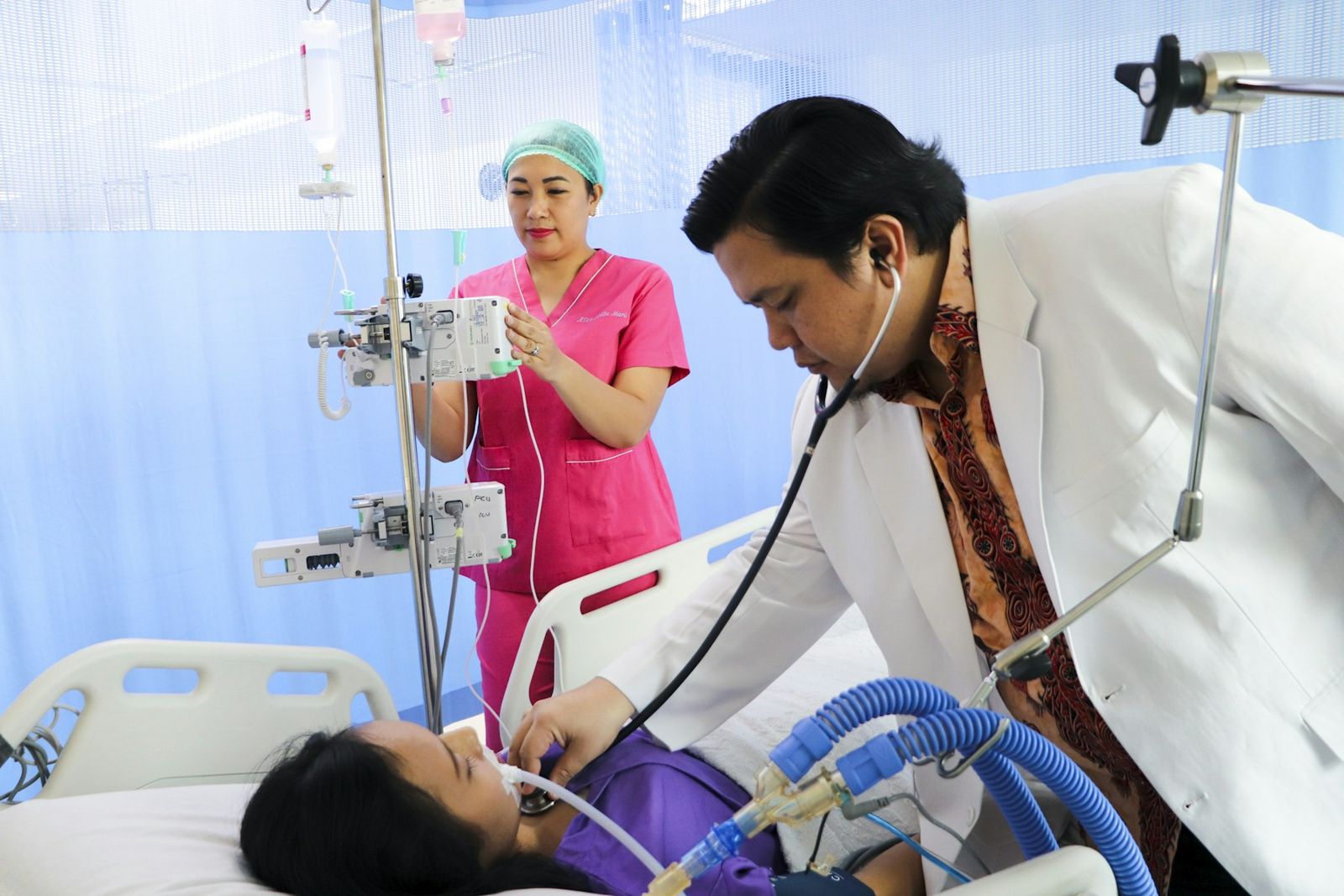 A doctor examining a patient in the hospital